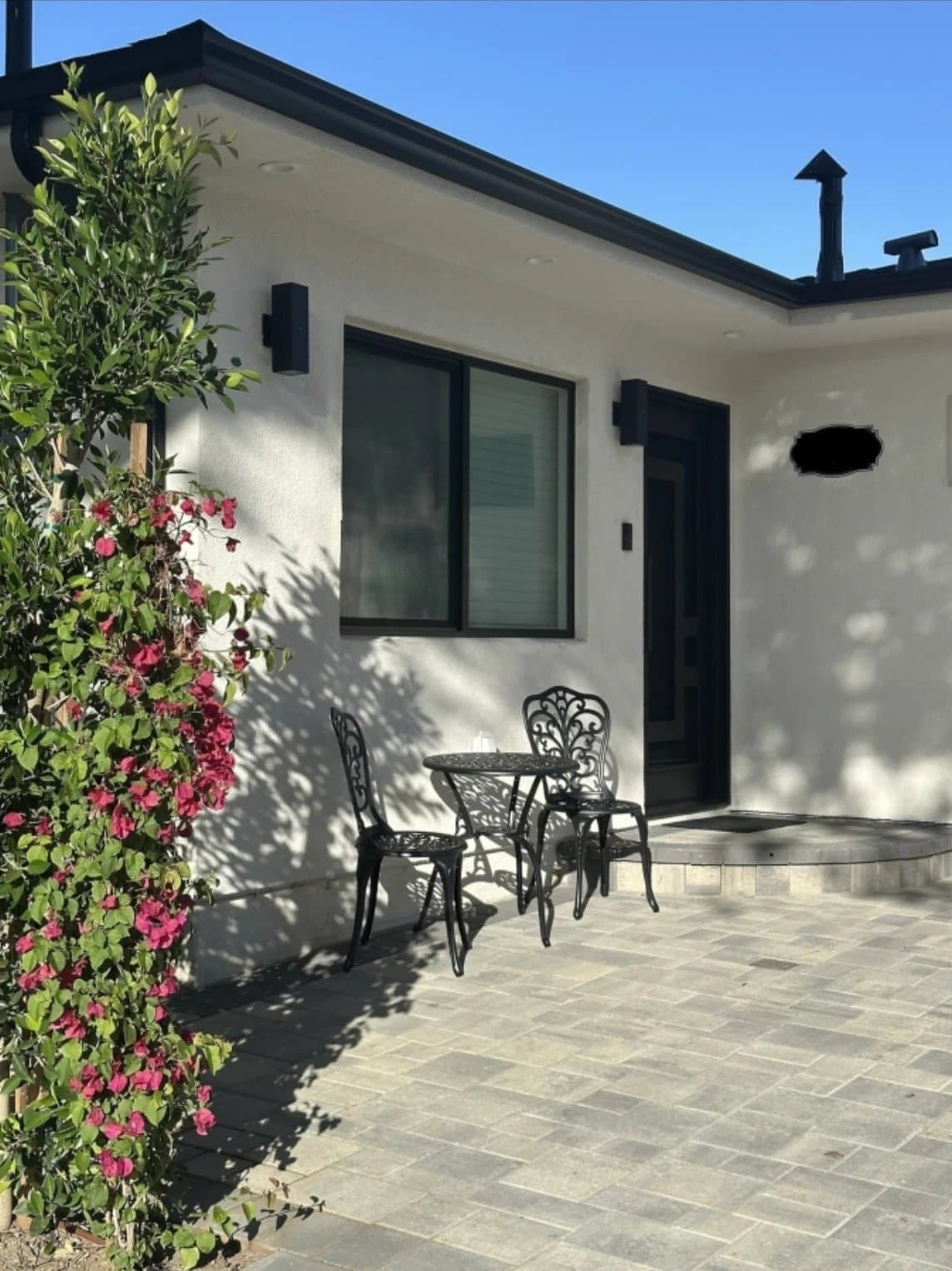 Private ADU entrance with bougainvillea and bistro set